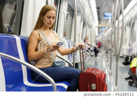 Woman using phone inside subway Woman using phone inside subway 45288513
