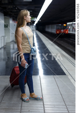 Woman on underground platform waiting train 45288568