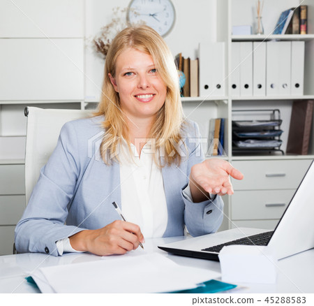 Female business consultant sitting at workplace Female business consultant sitting at workplace 45288583