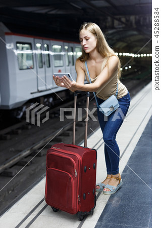 Girl using phone on subway station Girl using phone on subway station 45288584