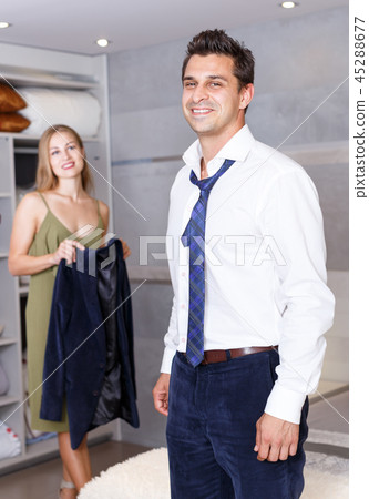 Man in bedroom and woman with his jacket Man in bedroom and woman with his jacket 45288677