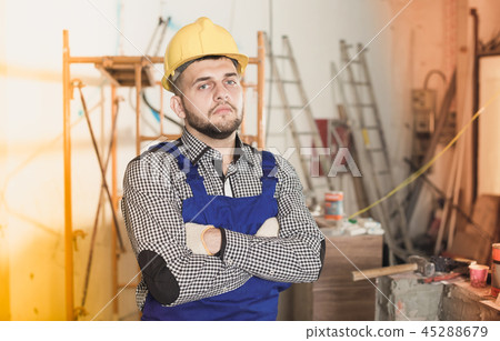 Portrait of builder which is repearing Portrait of builder which is repearing 45288679