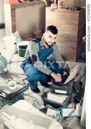 Worker is choosing tools in suitcase for work at the object. 45288680