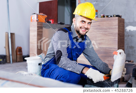 Builder is choosing tools in suitcase for work 45288726