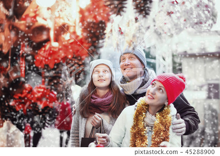 Couple with teen girl choosing decoration 45288900
