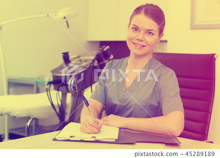 Cosmetologist working with documents 45289189