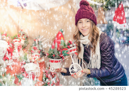 Portrait of young girl choosing xmas gifts Portrait of young girl choosing xmas gifts 45289323