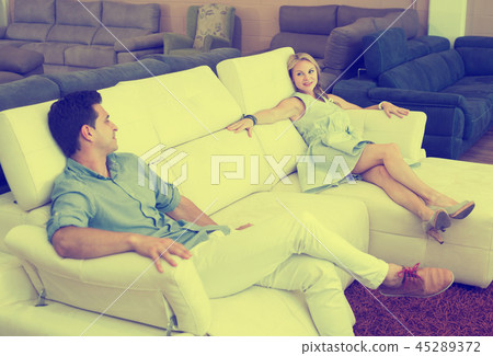 Happy Family are choosing sofa together Happy Family are choosing sofa together 45289372