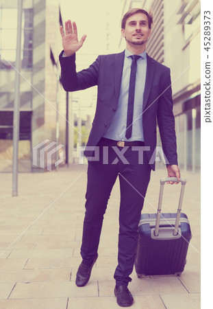 Portrait of cheerful male going with bag Portrait of cheerful male going with bag 45289373
