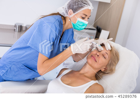Woman during beauty facial injections Woman during beauty facial injections 45289376