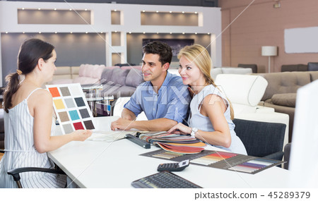Couple who are consulting with the assistent Couple who are consulting with the assistent 45289379