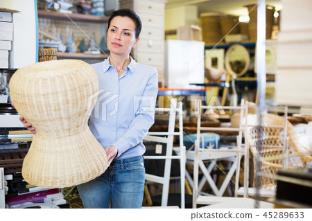 Female choosing straw pouf Female choosing straw pouf 45289633