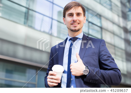 Businessman in suit with cup of coffee Businessman in suit with cup of coffee 45289637