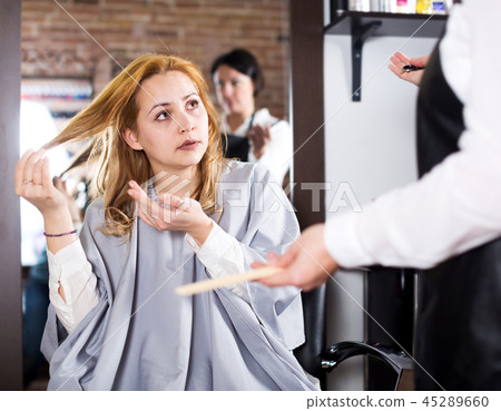 Young woman is not happy with her hair 45289660