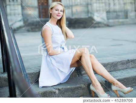 portrait of woman sitting on steps portrait of woman sitting on steps 45289700
