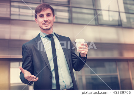 Businessman in suit with cup of coffee 45289706