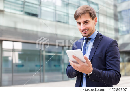 Professional male in jacket working at electonic device 45289707