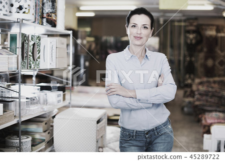 Adult woman buyer standing in shopping room with decor for home Adult woman buyer standing in shopping room with decor for home 45289722