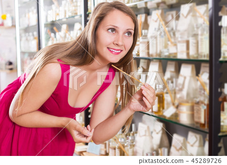 Female choosing sweet perfume lotion Female choosing sweet perfume lotion 45289726