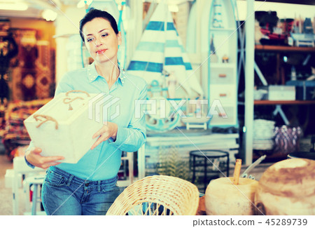 Woman standing with wooden box Woman standing with wooden box 45289739