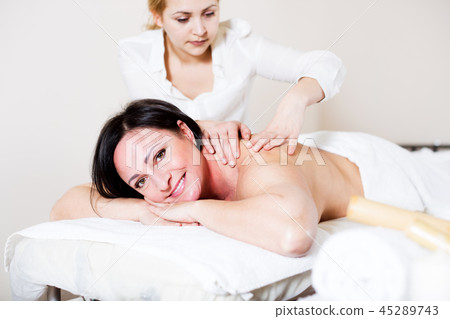 Adult woman very happy with procedure of massage Adult woman very happy with procedure of massage 45289743