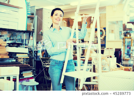 Female choosing stepladder in store Female choosing stepladder in store 45289773