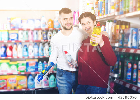 Couple choose some detergents Couple choose some detergents 45290056