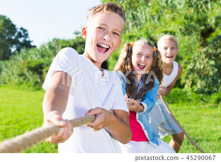 Children pulling rope outdoors 45290067