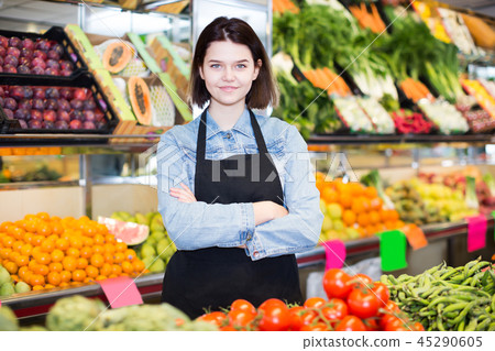 Positive woman seller displaying assortment 45290605