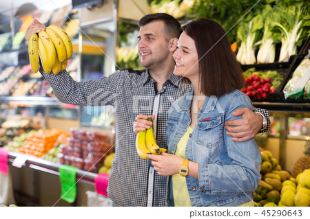 Couple choosing fruit Couple choosing fruit 45290643