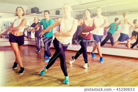 Adults having group fitness class Adults having group fitness class 45290653