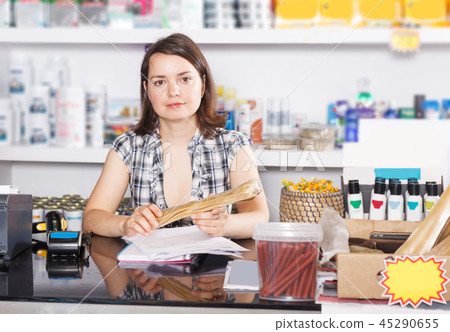 seller working with documents and goods in pet store seller working with documents and goods in pet store 45290655