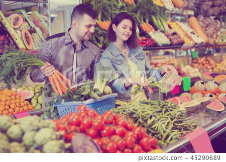 Woman and man are deciding on vegetables Woman and man are deciding on vegetables 45290689