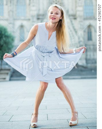 Glad female moving at the street in summer 45290707