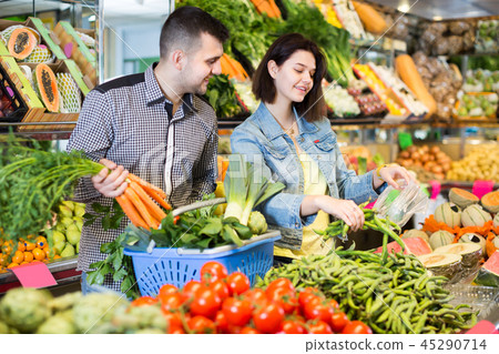 Girl and guy are deciding on vegetables 45290714