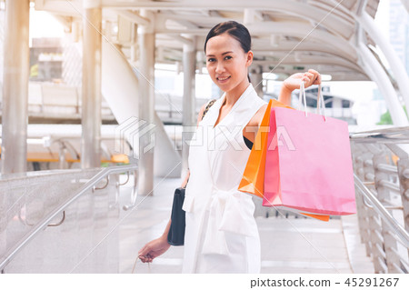 Happy woman with shopping bags enjoying in shop Happy woman with shopping bags enjoying in shop 45291267