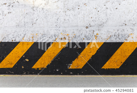 Concrete wall with striped caution pattern Concrete wall with striped caution pattern 45294081