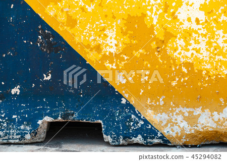 Grungy concrete road block, yellow and blue 45294082