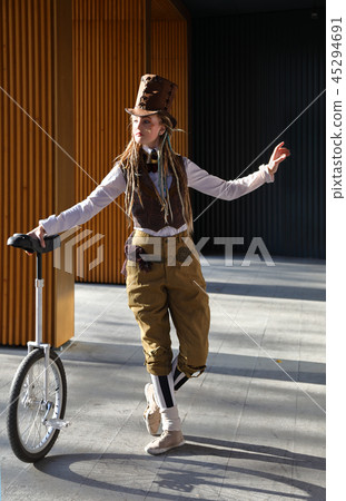 Pretty girl in a fantasy clothes with unicycle Pretty girl in a fantasy clothes with unicycle 45294691