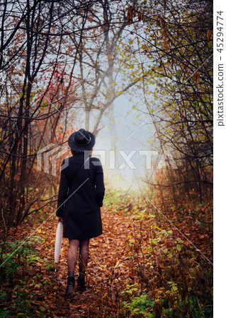 A young woman sneaks through the thickets 45294774