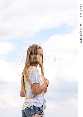 young girl on a background of clouds young girl on a background of clouds 45294852