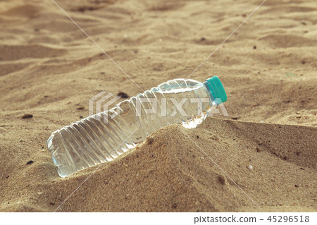 pet bottle with water on the desert. A bottle of water lying in the sand hot desert. pet bottle with water on the desert. A bottle of water lying in the sand hot desert. 45296518