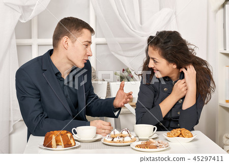 romantic couple drinking tea with cookies romantic couple drinking tea with cookies 45297411