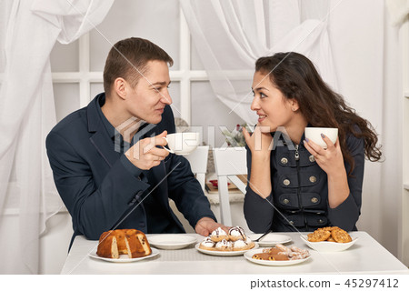 romantic couple drinking tea with cookies romantic couple drinking tea with cookies 45297412