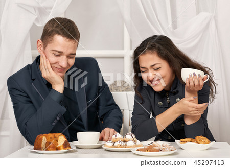 romantic couple drinking tea with cookies romantic couple drinking tea with cookies 45297413
