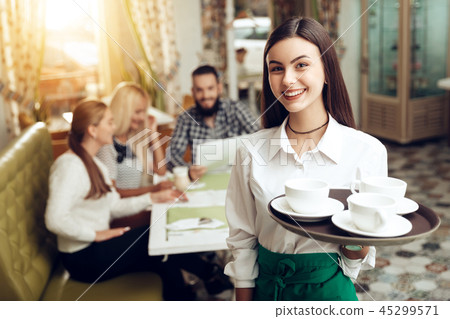Portrait smiling young waitress standing in cafe Portrait smiling young waitress standing in cafe 45299571