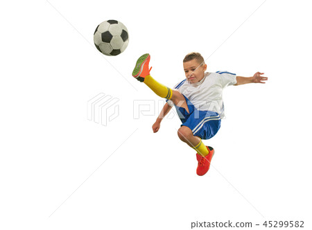 Young boy with soccer ball doing flying kick Young boy with soccer ball doing flying kick 45299582