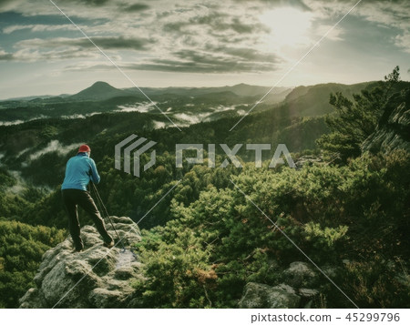 Silhouette of photographer at work during sunset 45299796