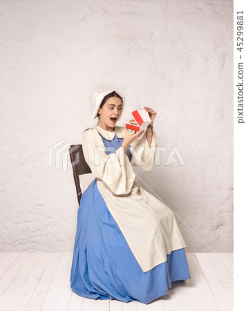 Medieval Woman in Historical Costume Wearing Corset Dress and Bonnet. Medieval Woman in Historical Costume Wearing Corset Dress and Bonnet. 45299881