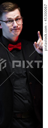 Portrait of confident handsome elegant responsible businessman with idea gesture on black background Portrait of confident handsome elegant responsible businessman with idea gesture on black background 45300067